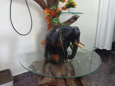 a statue of an elephant on a glass table at BHASURI VILLA Attappady in Varagampadi