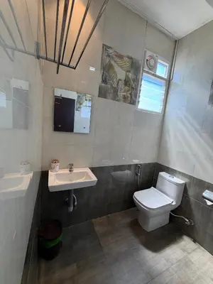 a bathroom with a toilet and a sink at Vanam Holidays in Ooty