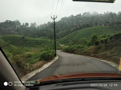 a view from the inside of a car driving down a road at Mountain View cottage Mankulam in Munnar