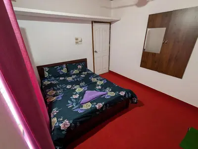 a small bedroom with a bed with a purple blanket at kaffee valley - Kurumbalakotta in Padinjarathara