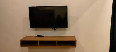 a flat screen tv hanging on a wall at The Lavender Woods in Vythiri
