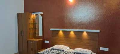 a bedroom with a wooden headboard and a mirror at The Lavender Woods in Vythiri