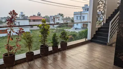 a balcony with potted plants and stairs in a building at SindooRa in Mysore