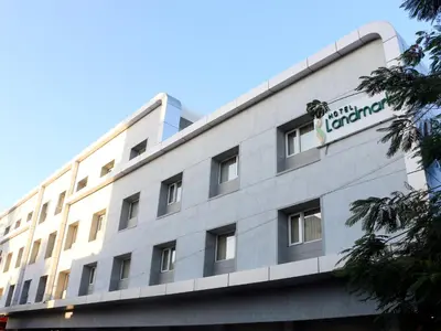 a building with a sign on top of it at Hotel LandmarK Coimbatore in Coimbatore