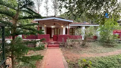 a house with a red porch and a red brick walkway at Wild Valley Club in Masinagudi