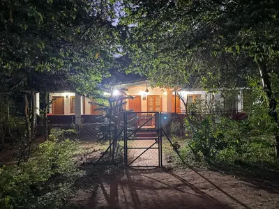 a gate in front of a house at night at Wild Valley Club in Masinagudi
