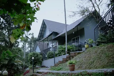 a house on the side of a hill at Mountain Vibes Resort Wayanad in Wayanad