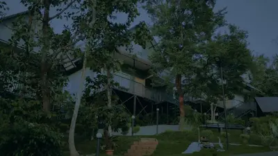a building with trees in front of it at Mountain Vibes Resort Wayanad in Wayanad