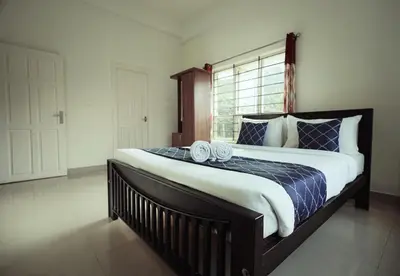 a bedroom with a large bed with two towels on it at Caravan holiday homes Vythiri in Vythiri