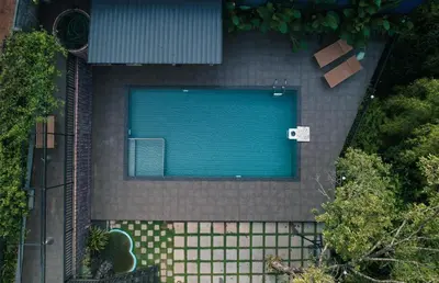 an overhead view of a swimming pool in a backyard at Caravan holiday homes Vythiri in Vythiri