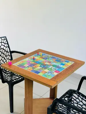 a wooden table with a board on top of it at Caravan holiday homes Vythiri in Vythiri