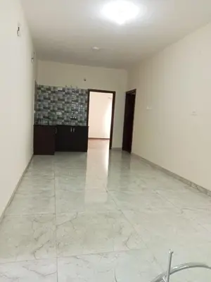 an empty room with white walls and a tile floor at Pinehill Suites in Ooty