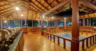 a large room with wooden tables and benches in it at Lazo Areca Resort , Coorg in Madikeri