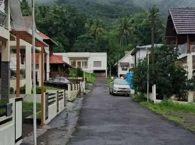 a car parked on a street in a village at SkYVIEW VILLA in Athirappilly