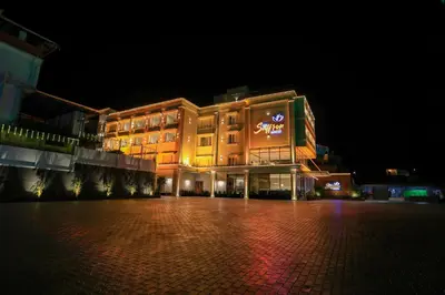 a large building is lit up at night at Hotel Saffron Wayanad in Sultan Bathery