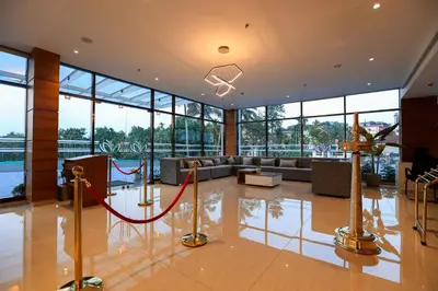 a living room with a couch and a red rope at Hotel Saffron Wayanad in Sultan Bathery