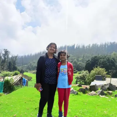 a man and a girl standing in a field at REHMANS HOMESTAY in Ooty
