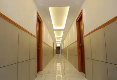 a hallway of a building with a row of lights at Hotel Vrindavan in Wayanad