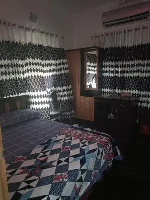 a bedroom with a bed with a quilt on it at Oxygen Home Stay in Agali