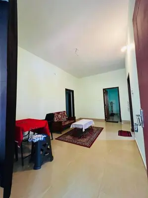 a living room with a couch and a table at Ocean Pearl in Kozhikode