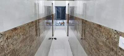 a hallway in a building with a glass wall at SAMPATH RESIDENCY in Palani