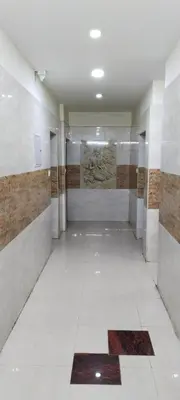 a room with a hallway with a tile floor and a wall at SAMPATH RESIDENCY in Palani