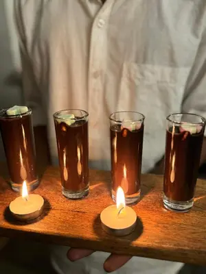a group of candles on a wooden tray at Bendheka - Cliff Front Cottages Coorg in Gonikoppal