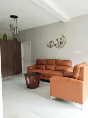 a living room with a couch and a table at INN THE MOUNTAIN'S in Kodaikānāl